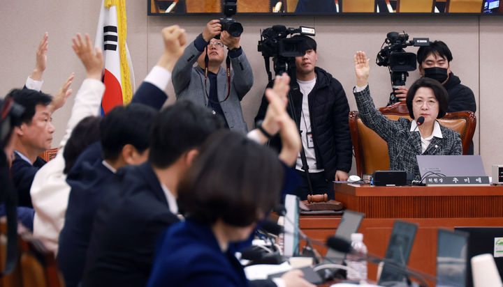 추미애 국회 법사위원장과 더불어민주당 등 의원들이 23일 서울 여의도 국회에서 열린 법제사법위원회 전체회의에서 안건 거수 표결에서 찬성표를 던지고 있다.  뉴시스